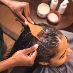 closeup-stylist-rinsing-clients-hair-sink-with-water-flowing-gently-bot